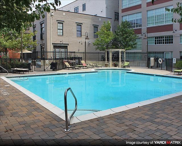a swimming pool in front of an apartment building