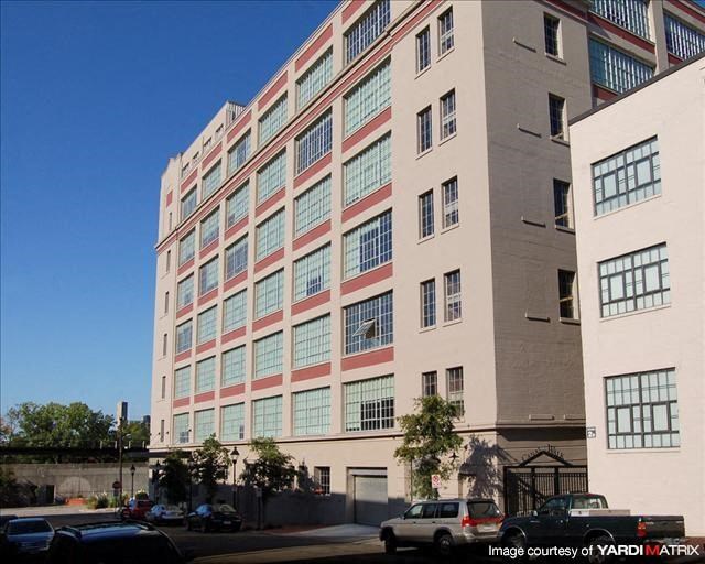 a large building with cars parked in front of it