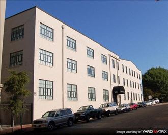 a large white building with cars parked in front of it