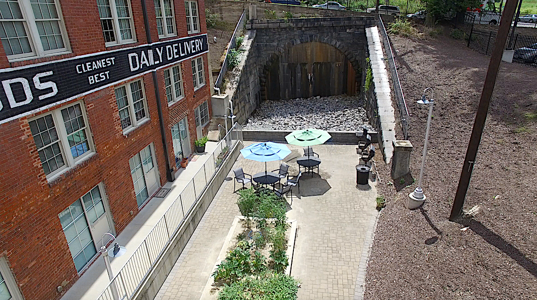 A view of a courtyard with a pool and a sign that says "CLEANEST DAILY DELIVERY BEST".