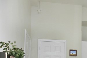 an open floor plan with a dining table and chairs and a kitchen with a refrigerator and microwave