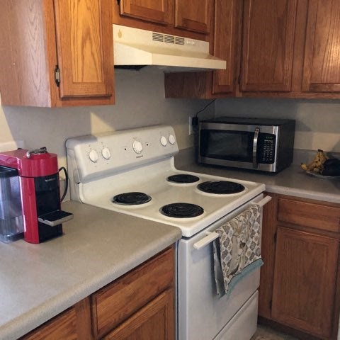 a kitchen with a stove and a microwave