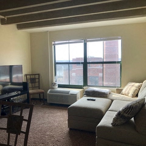 a living room with a couch and a tv