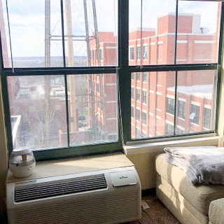 a room with a window and a bed and a radiator