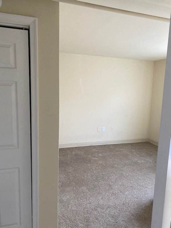 an empty room with white walls and a door