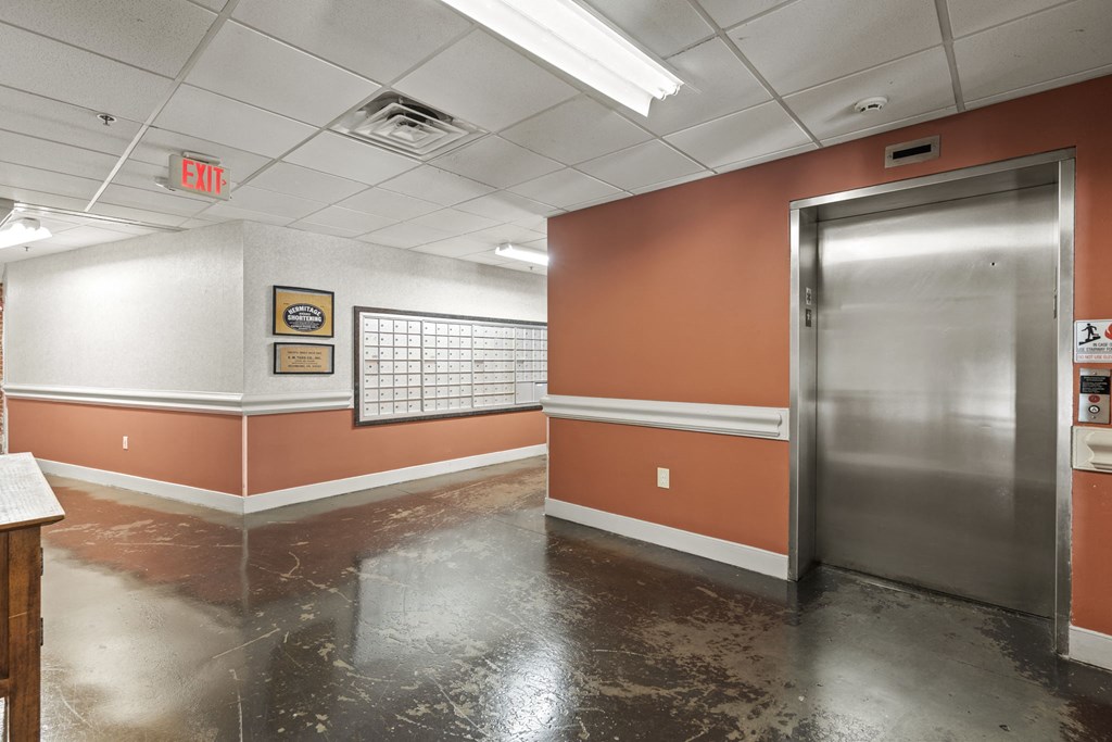 the lobby of a building with a metal door