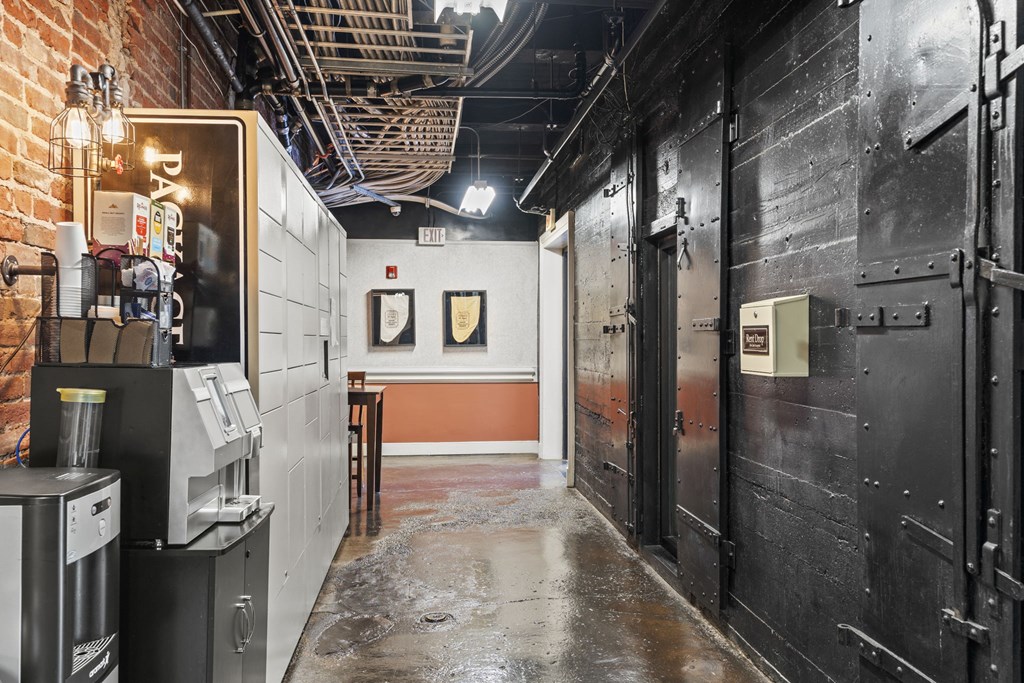 a room with a wet floor and black doors