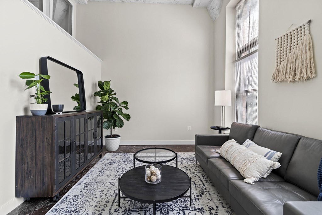 a living room with a leather couch and a coffee table