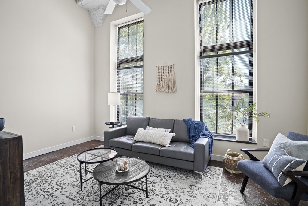 a living room with a couch and two windows