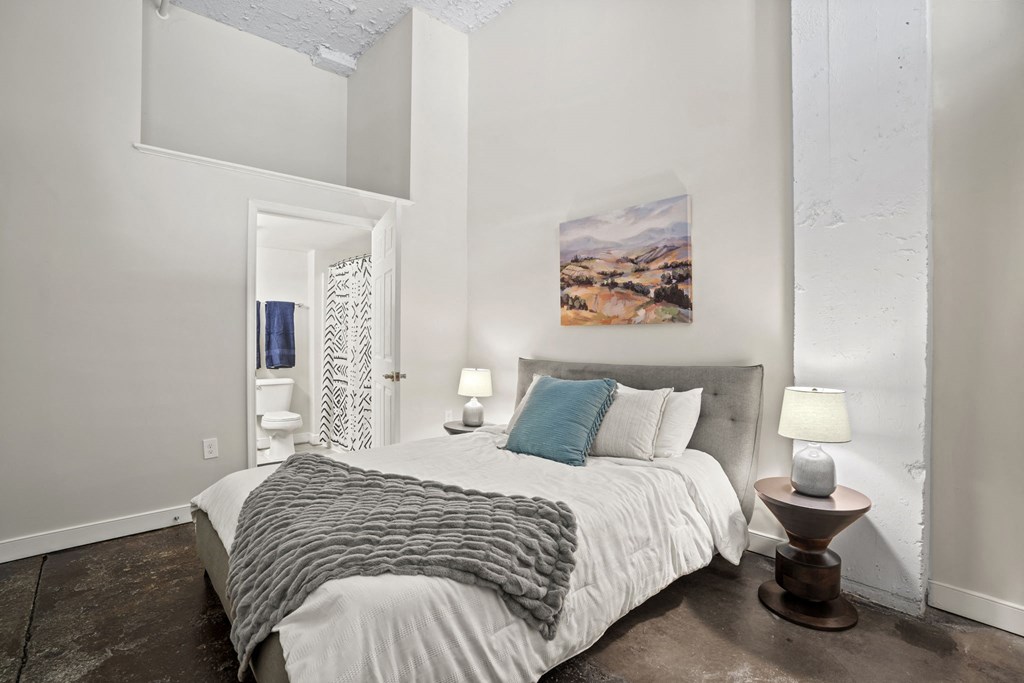 a bedroom with a large bed and a window