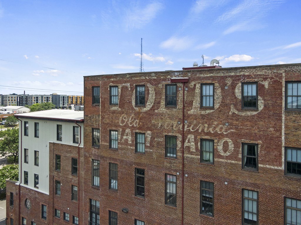 an old brick building with an old advertisement on it