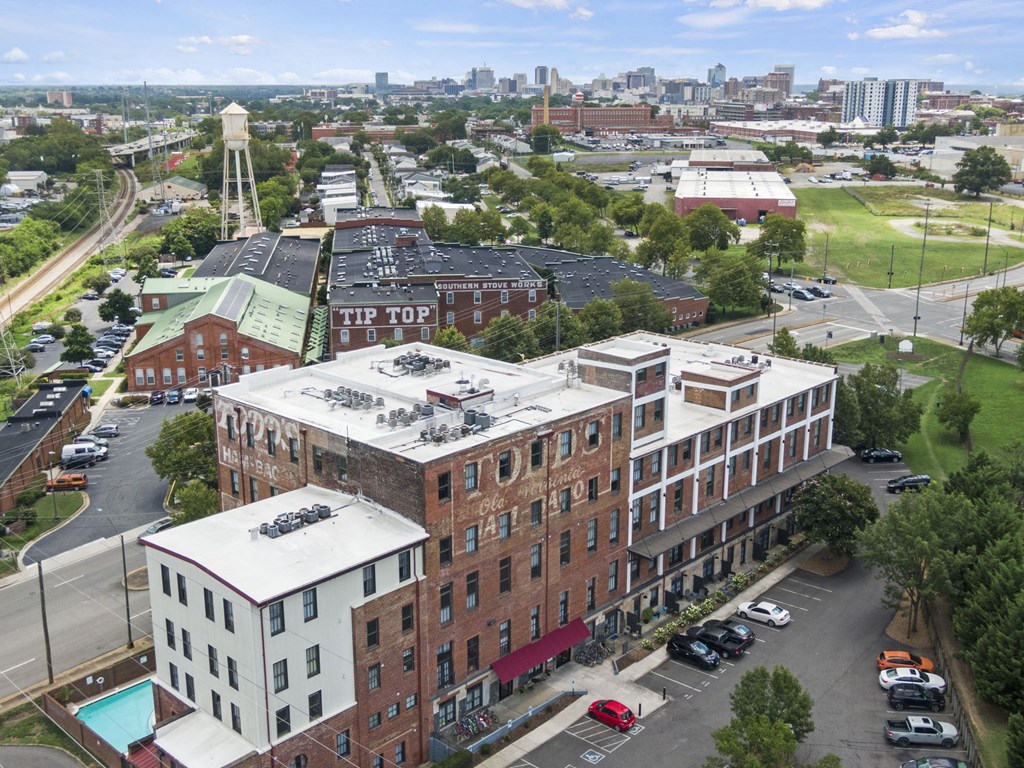 an aerial view of an apartment building with a city in the background