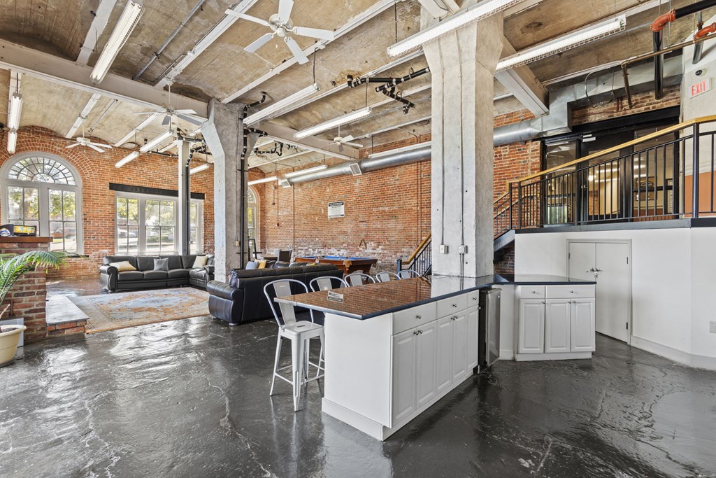 a kitchen with a large island in the middle of a living room