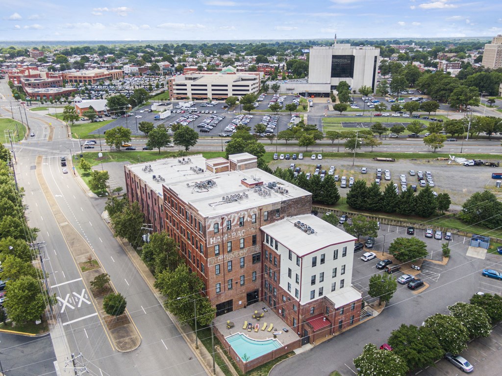 an aerial view of a building and a parking lot