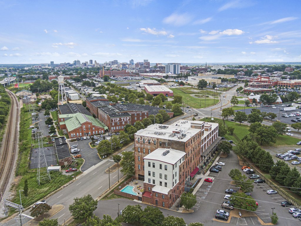 an aerial view of a city with buildings and cars on the street