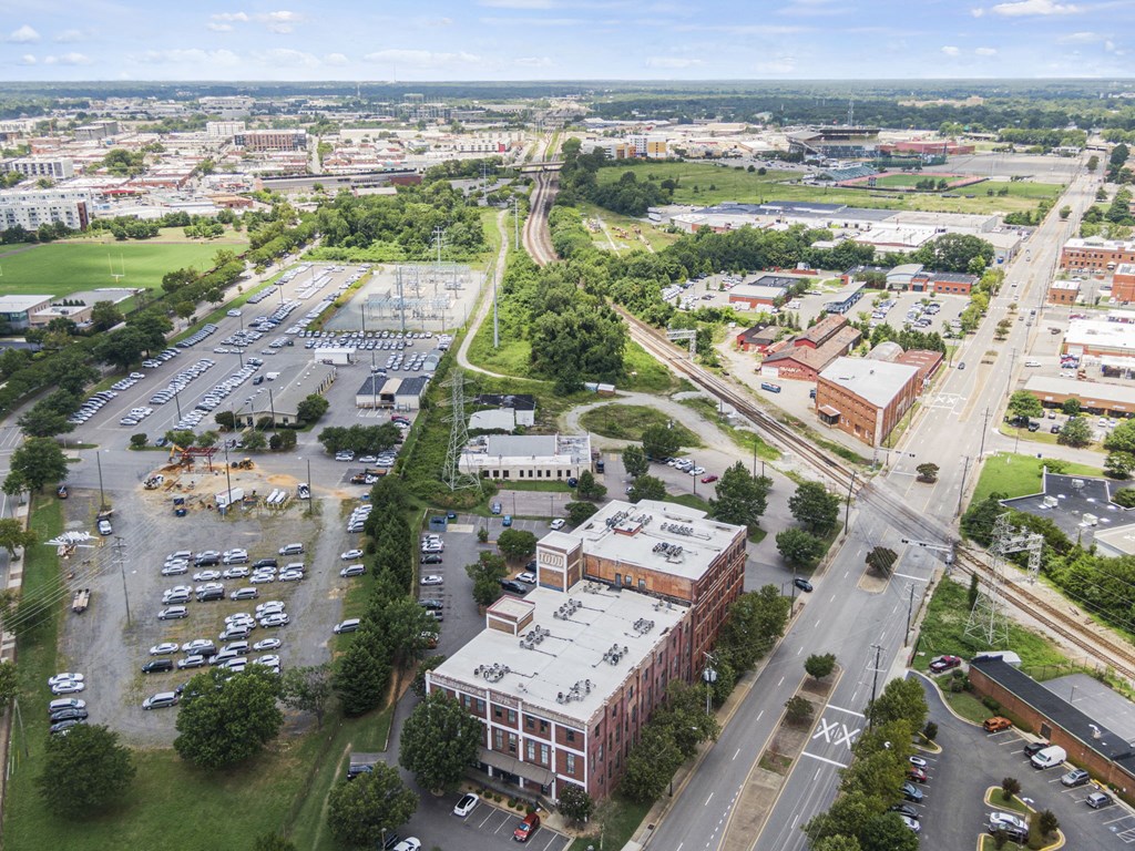 an aerial view of a city with buildings and cars
