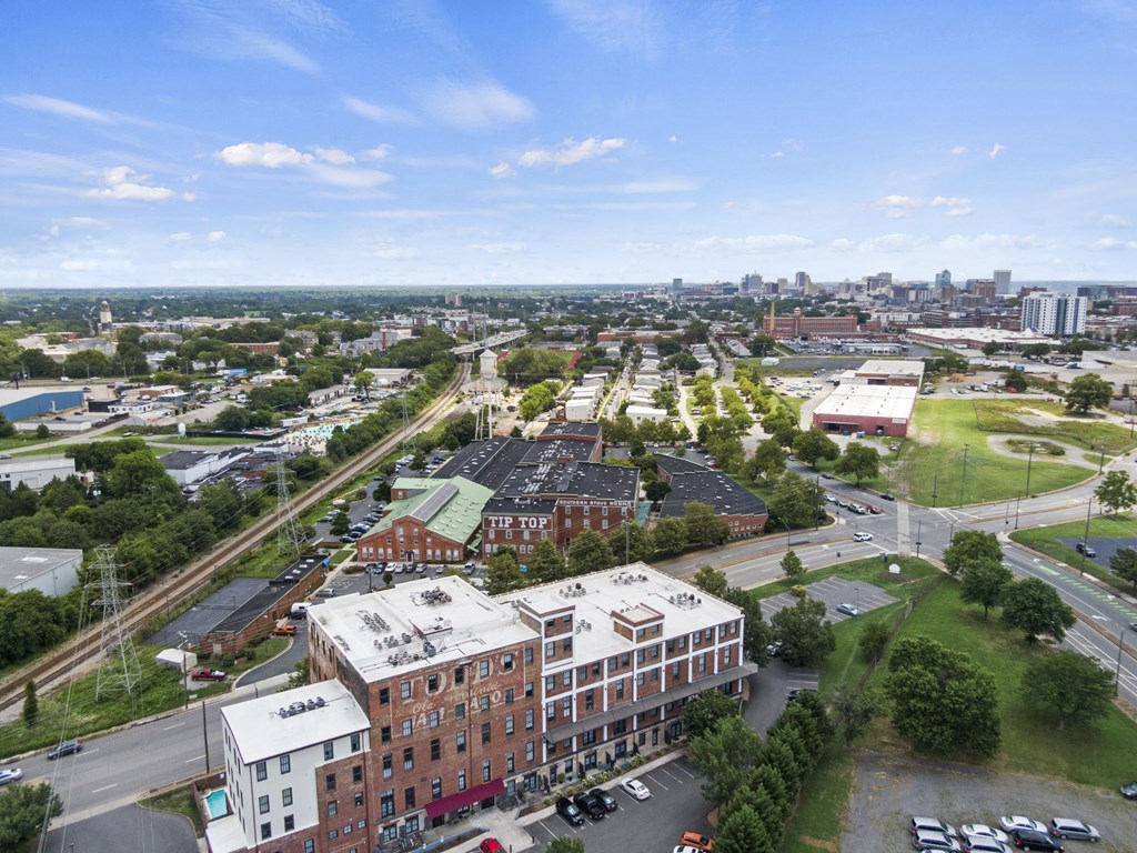 an aerial view of a city with buildings and cars on the street