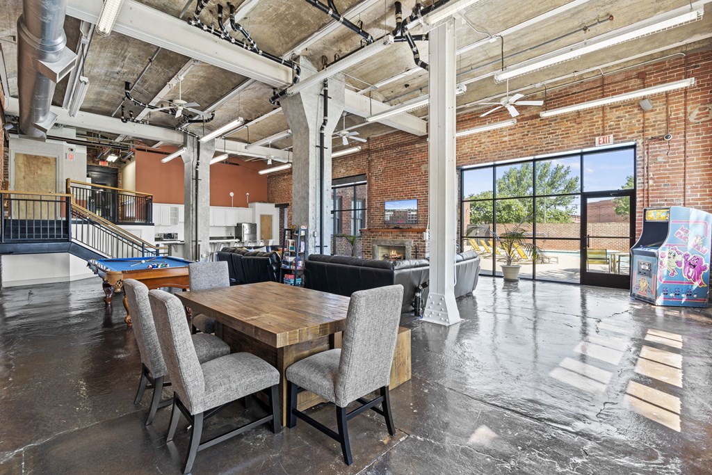 a living room with a table and chairs and a pool table