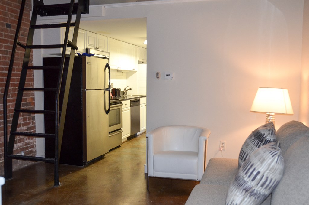 the living room and kitchen of a studio apartment