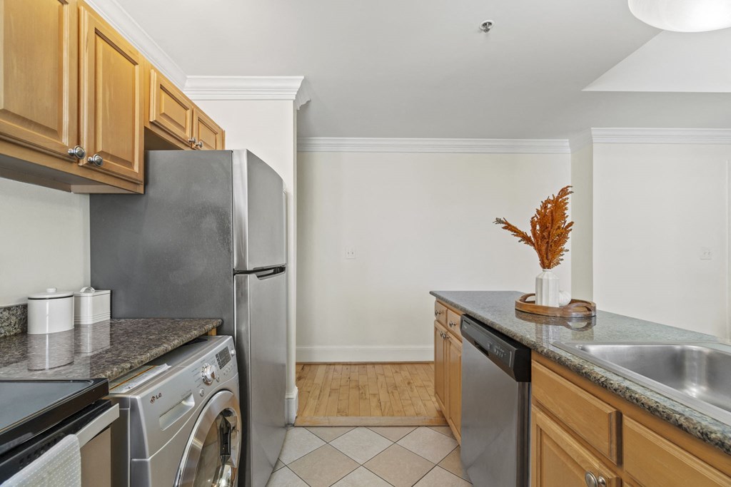 a kitchen with stainless steel appliances and wooden cabinets