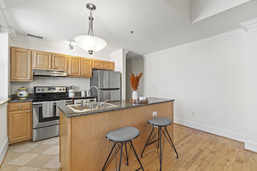 a kitchen with an island and two stools