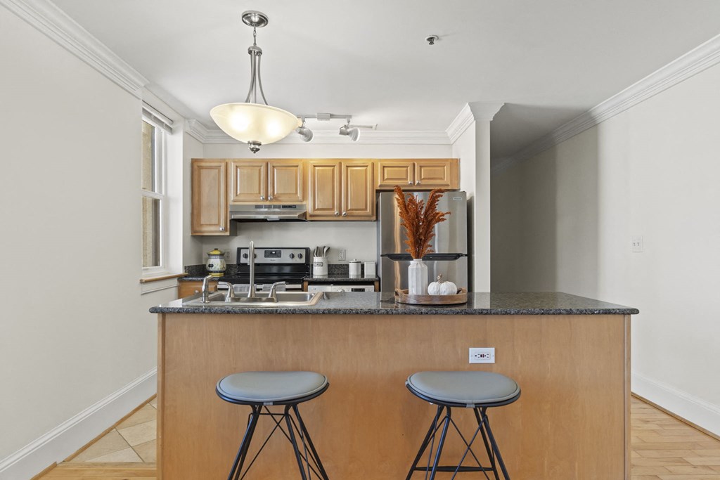 a kitchen with a counter top with two stools