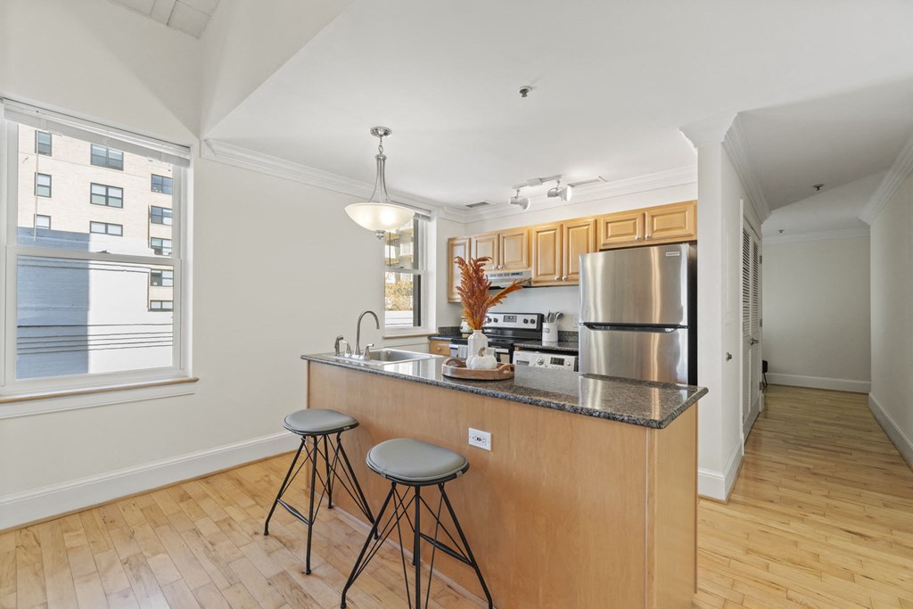 a kitchen with a island and two stools