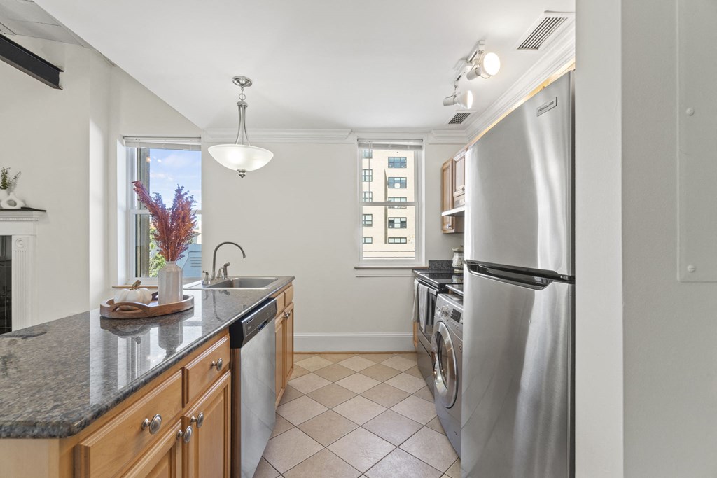 a kitchen with stainless steel appliances and a window