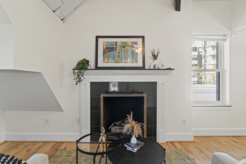 a living room with a fireplace and a black coffee table