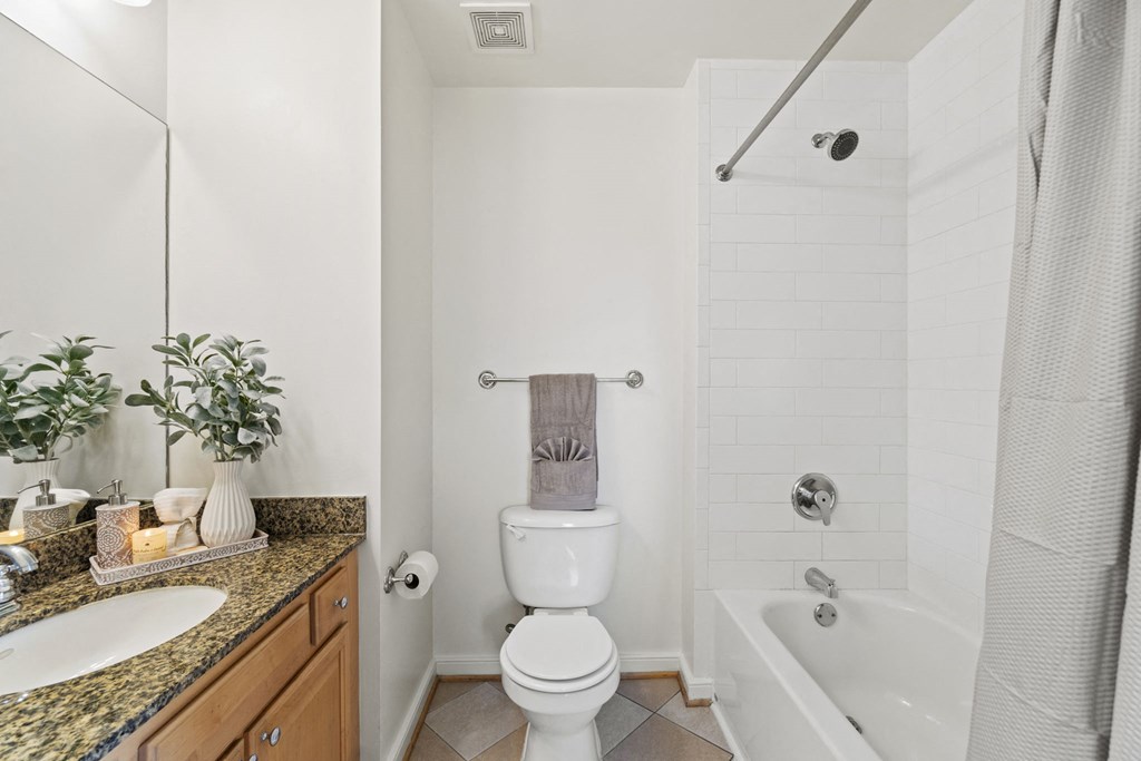 a bathroom with a toilet and a tub and a sink