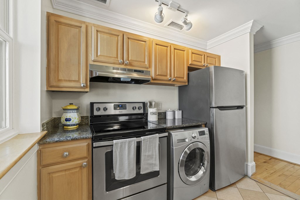 a kitchen with stainless steel appliances and wooden cabinets
