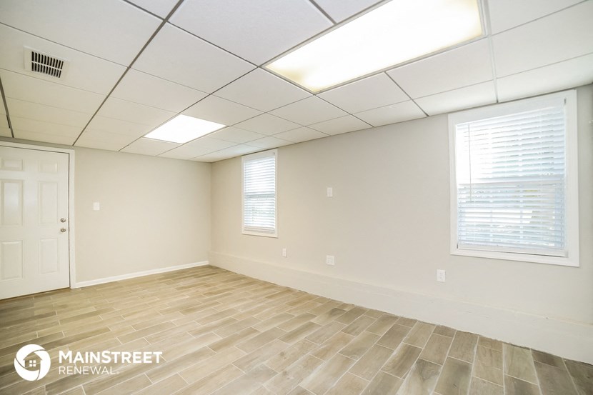 the interior of an empty room with white walls and wood floors