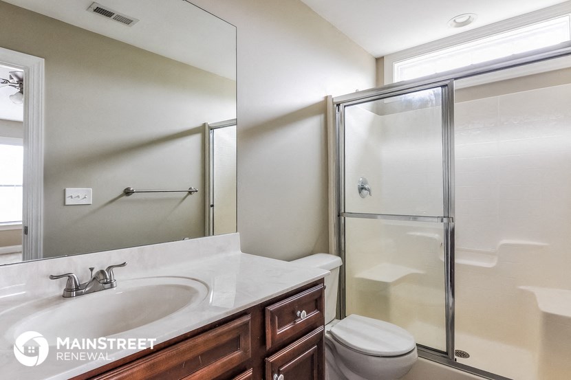 a bathroom with a sink and a shower and a toilet