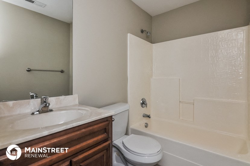 a bathroom with a sink toilet and a tub