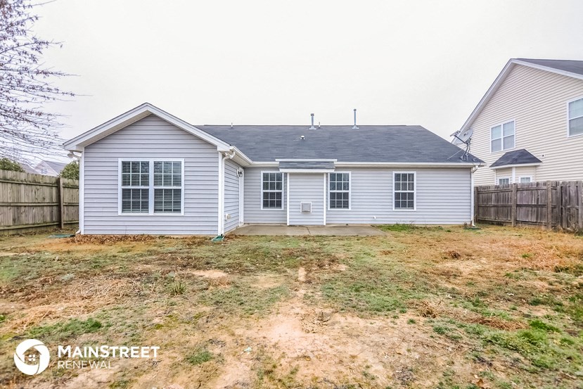a blue house with a yard in front of it