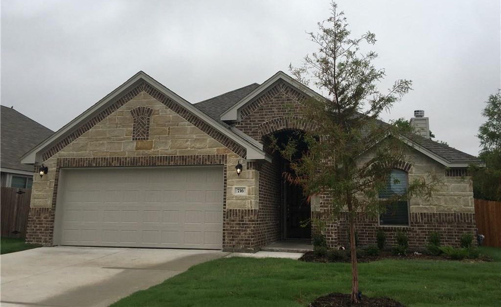 a brown brick house with a garage door