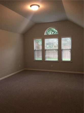an empty room with three windows in it