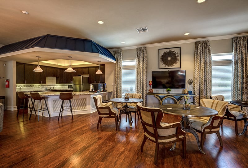 A modern kitchen with a dining table set for four.