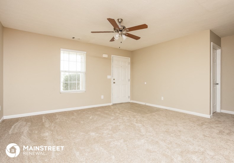 the master bedroom is spacious and has a ceiling fan