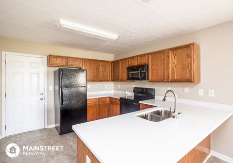 a kitchen with black appliances and white counter tops