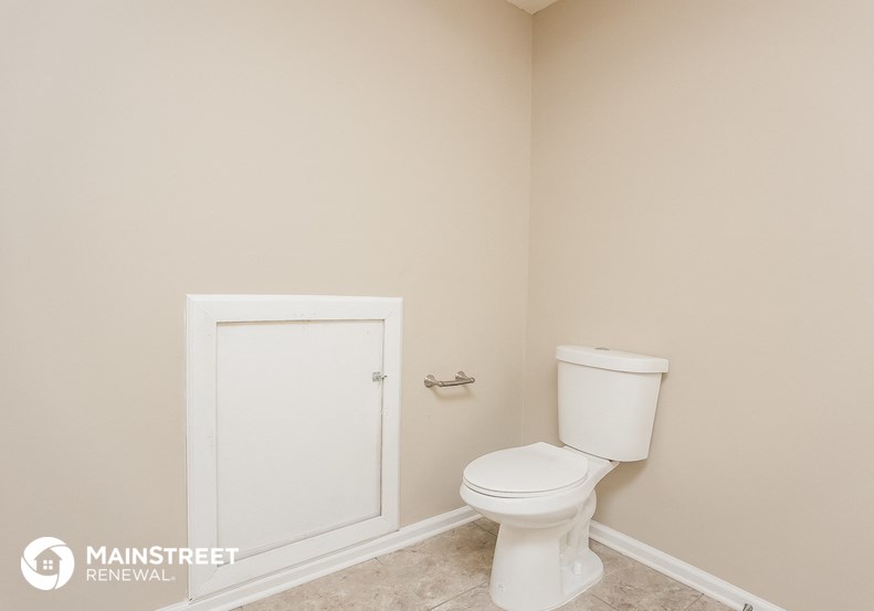a small bathroom with a toilet and a white door