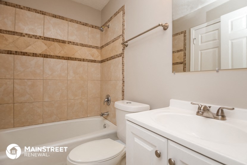 a bathroom with a sink toilet and a tub