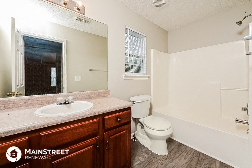 a bathroom with a sink toilet and a shower