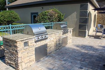 Outdoor kitchen with gas grills pool-side