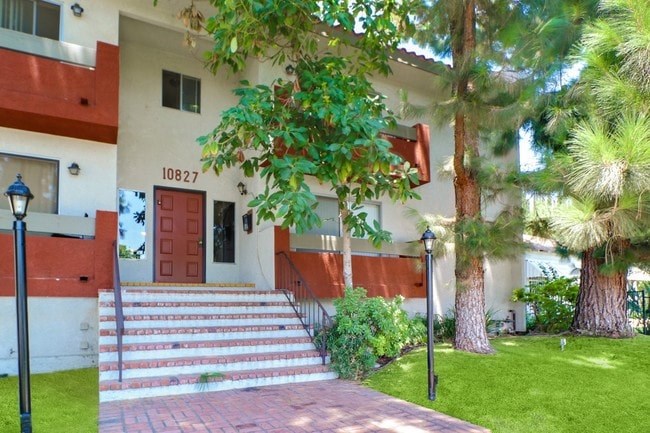 A house numbered 10827 is shown with a red door and steps leading up to it.