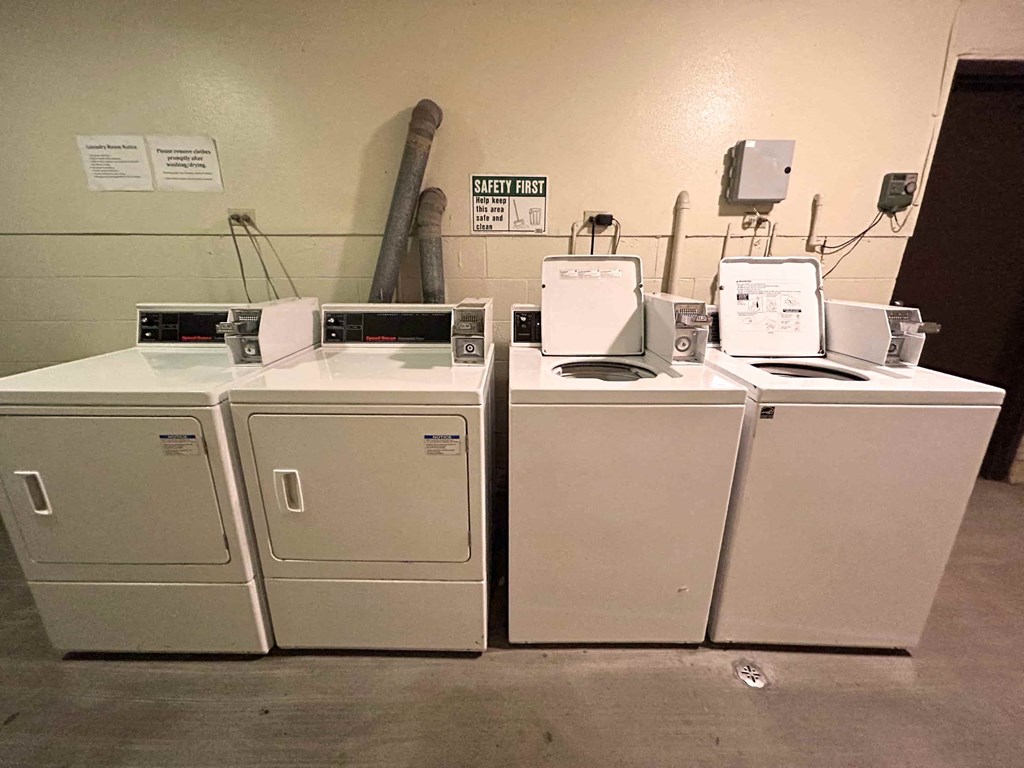 A row of white appliances are lined up in a room.