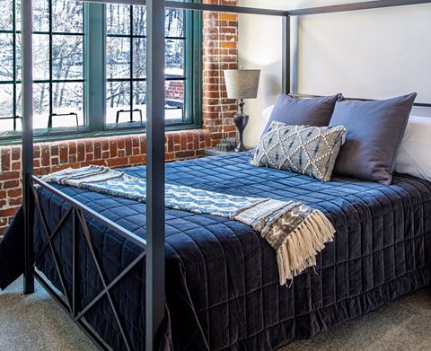 a bedroom with a bed and a window
