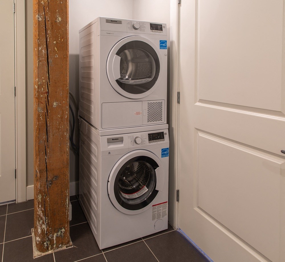 a front loading washer and dryer in a laundry room
