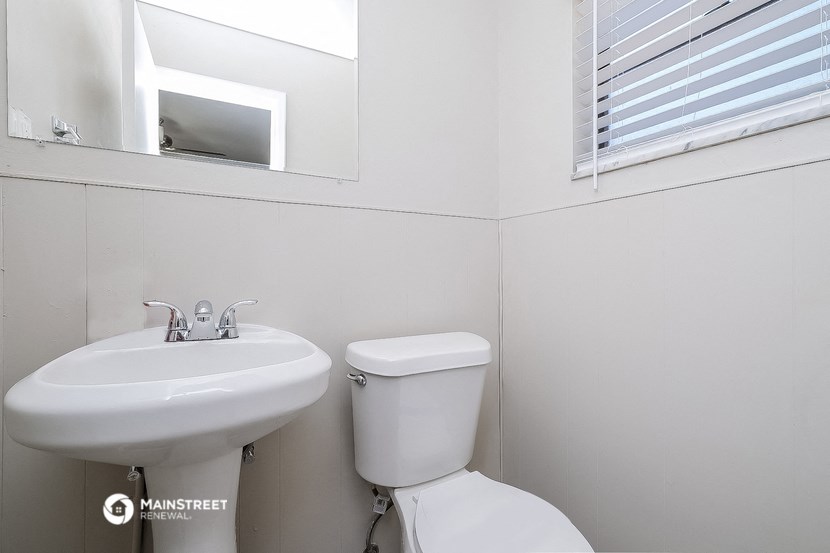 a bathroom with a sink and a toilet and a mirror