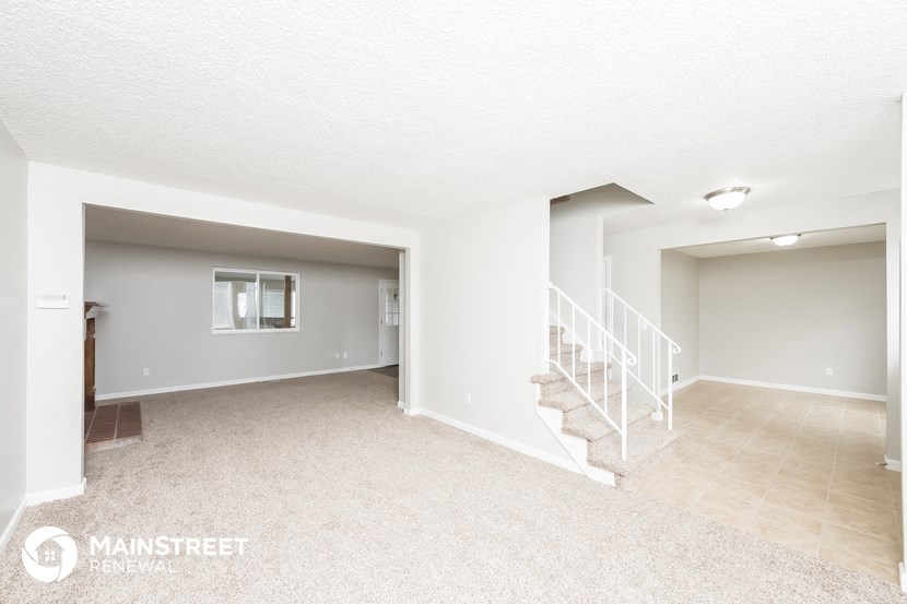 the living room and dining room with stairs to the second floor